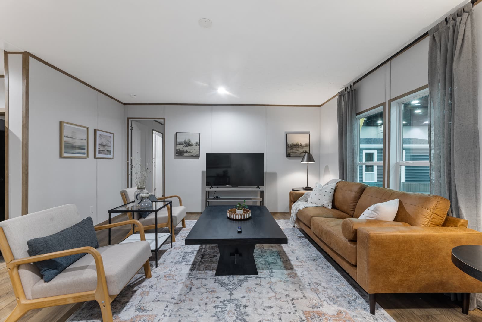 Living room. Sofa, two armchairs, television wall.