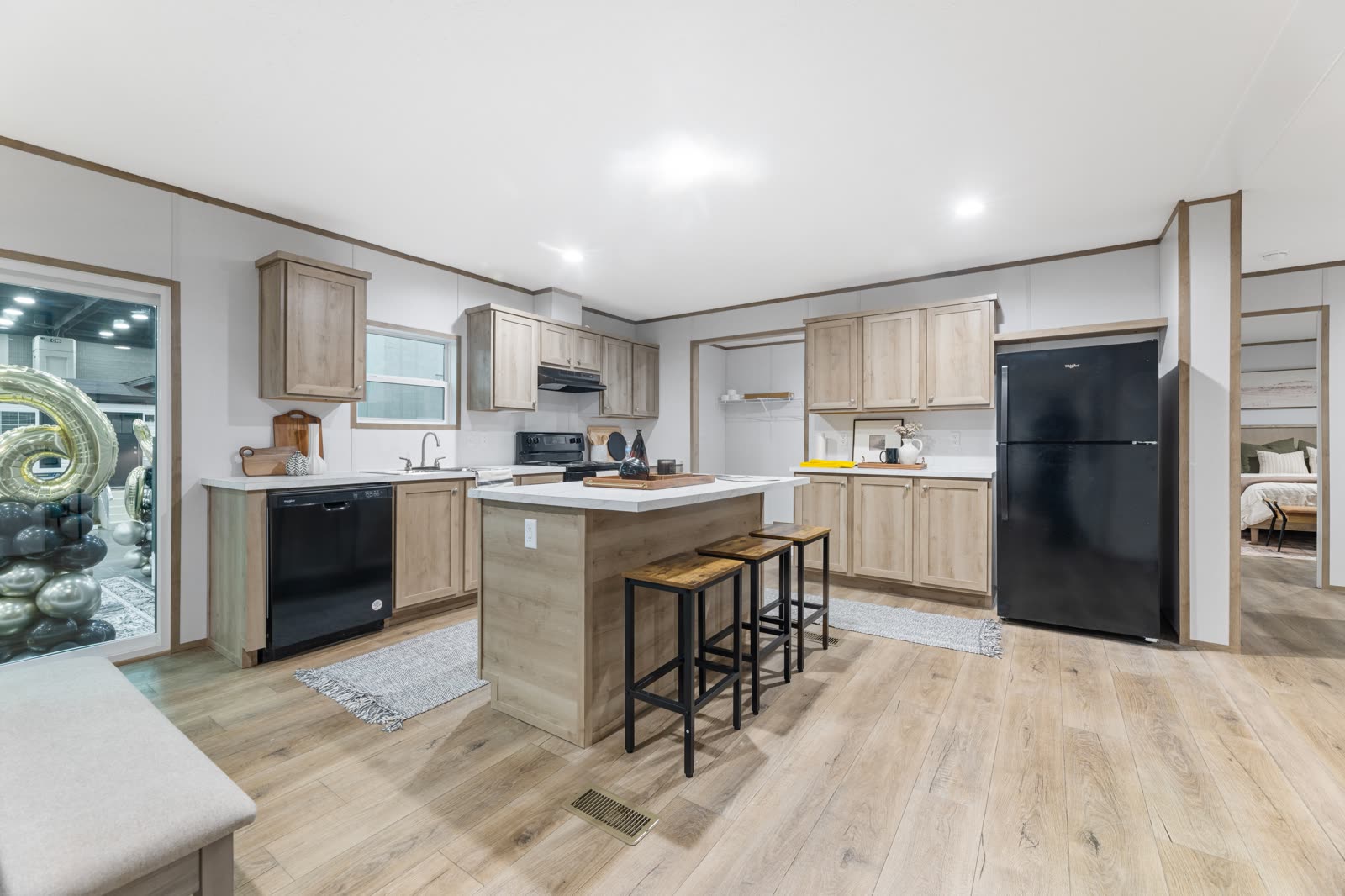 Kitchen island with seating. Pantry and refrigerator wall.