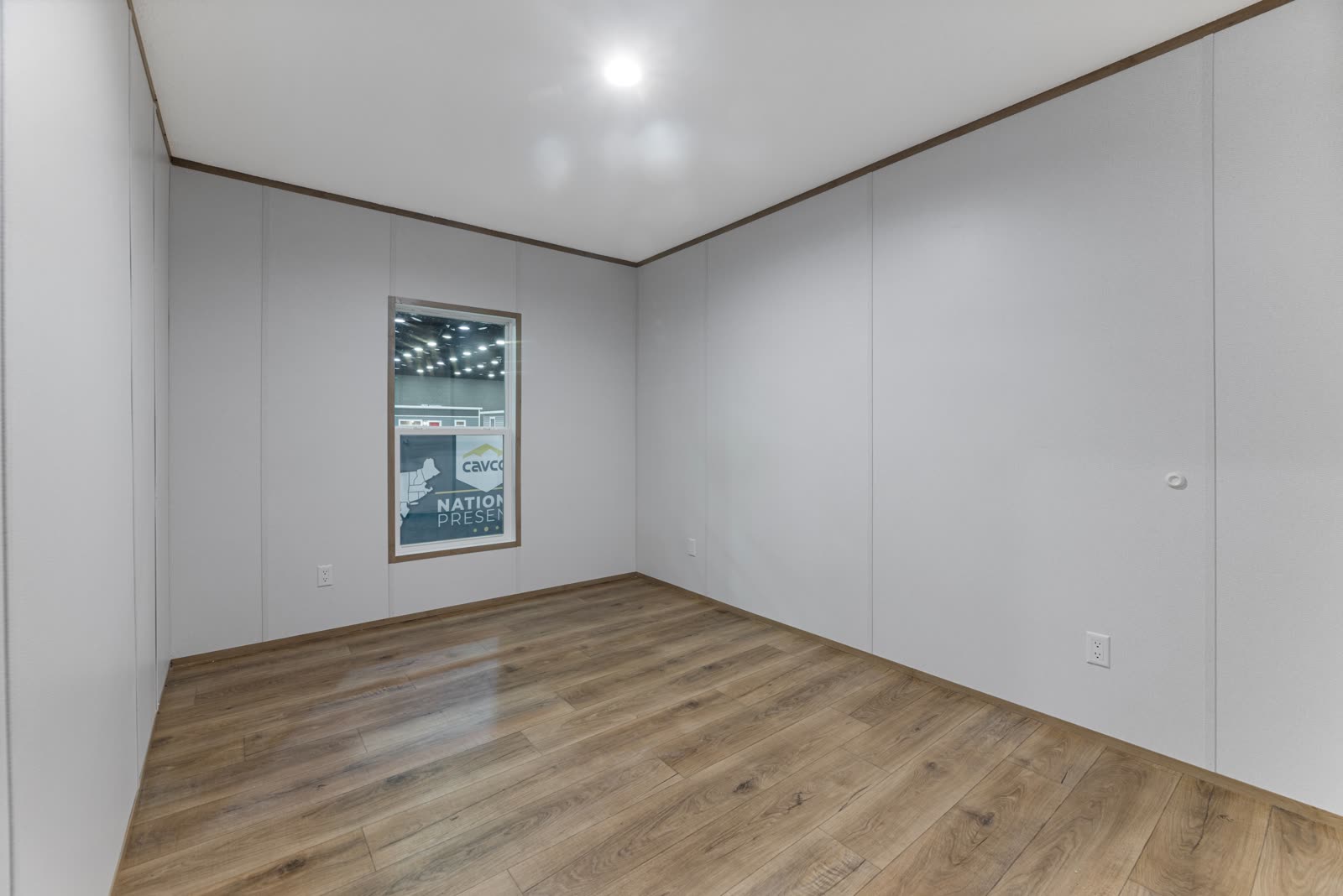 Bedroom 2. Empty, window to the lot.