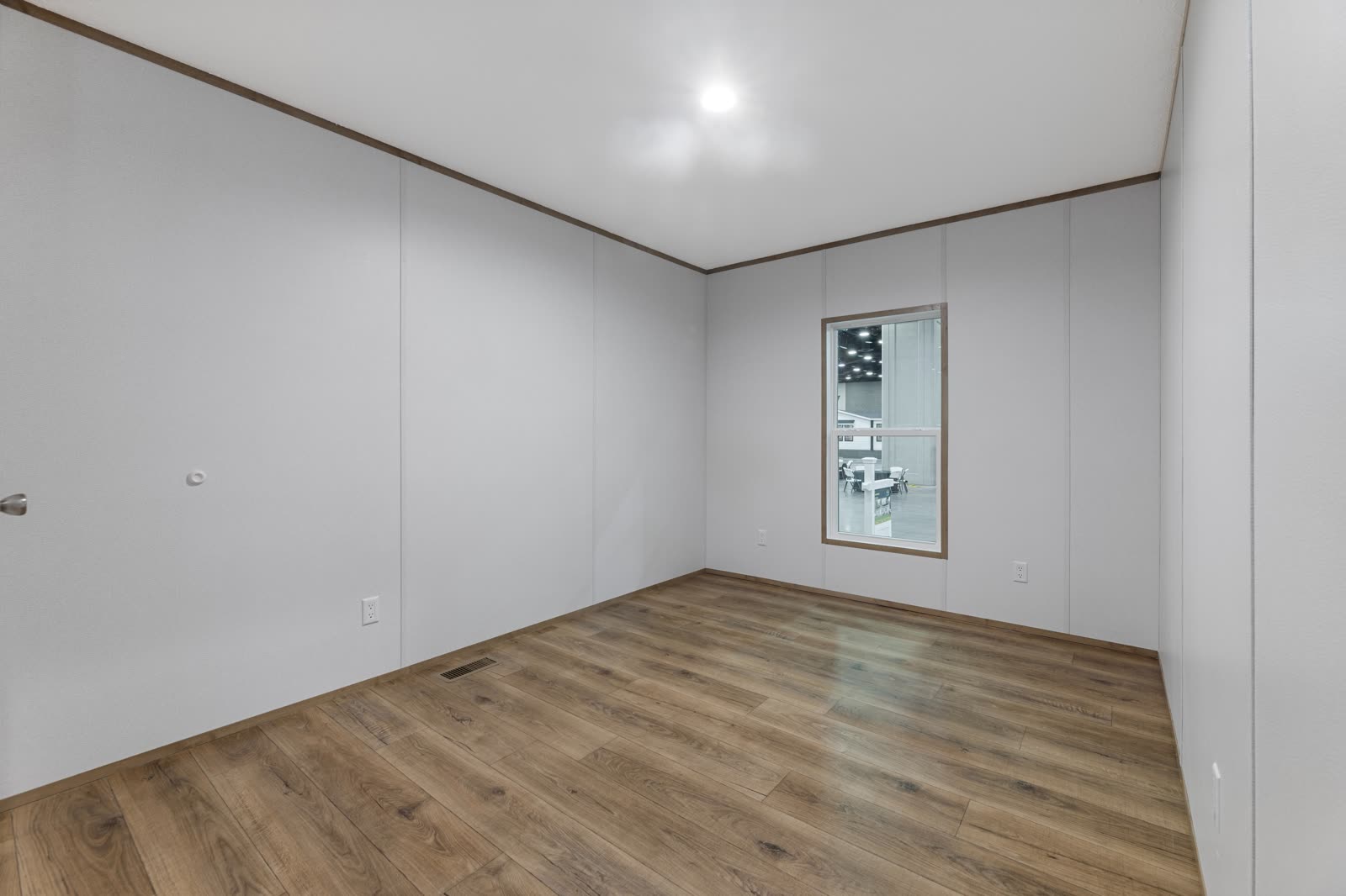 Bedroom 3. Empty, window to the lot.