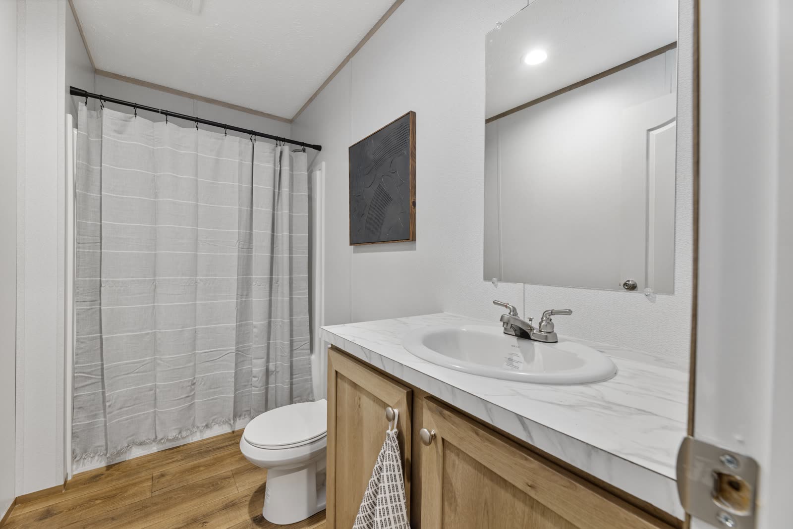Bath 2. Vanity and tub with shower.