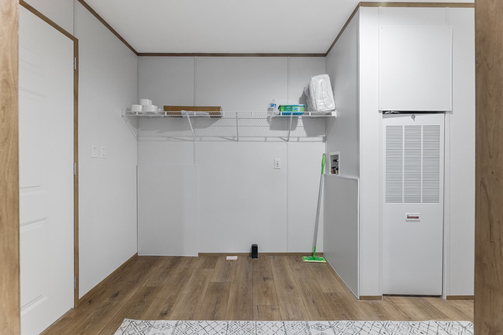 Utility room. Shelving, water heater, washer and dryer hookups.