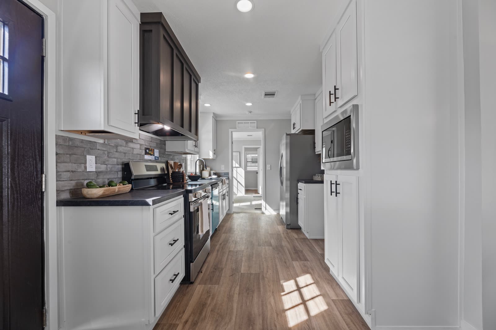 Kitchen from the front door. Galley toward the bedroom hall.