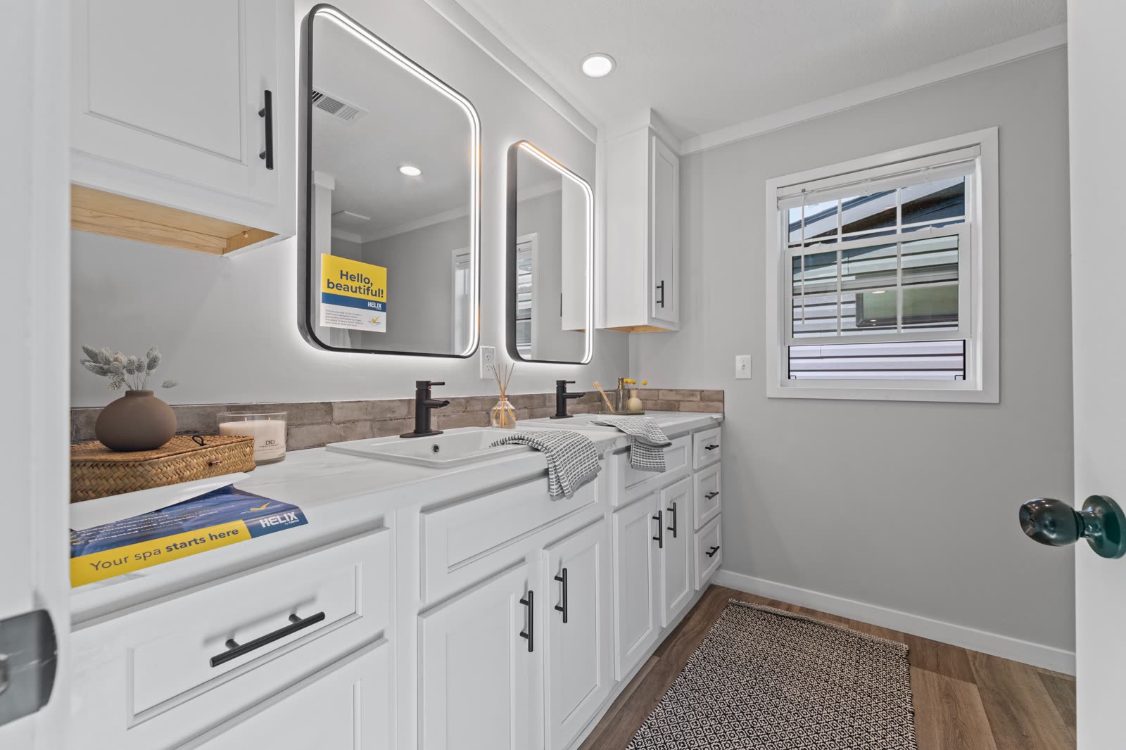 Bath 1. Double vanity, tile backsplash, window.