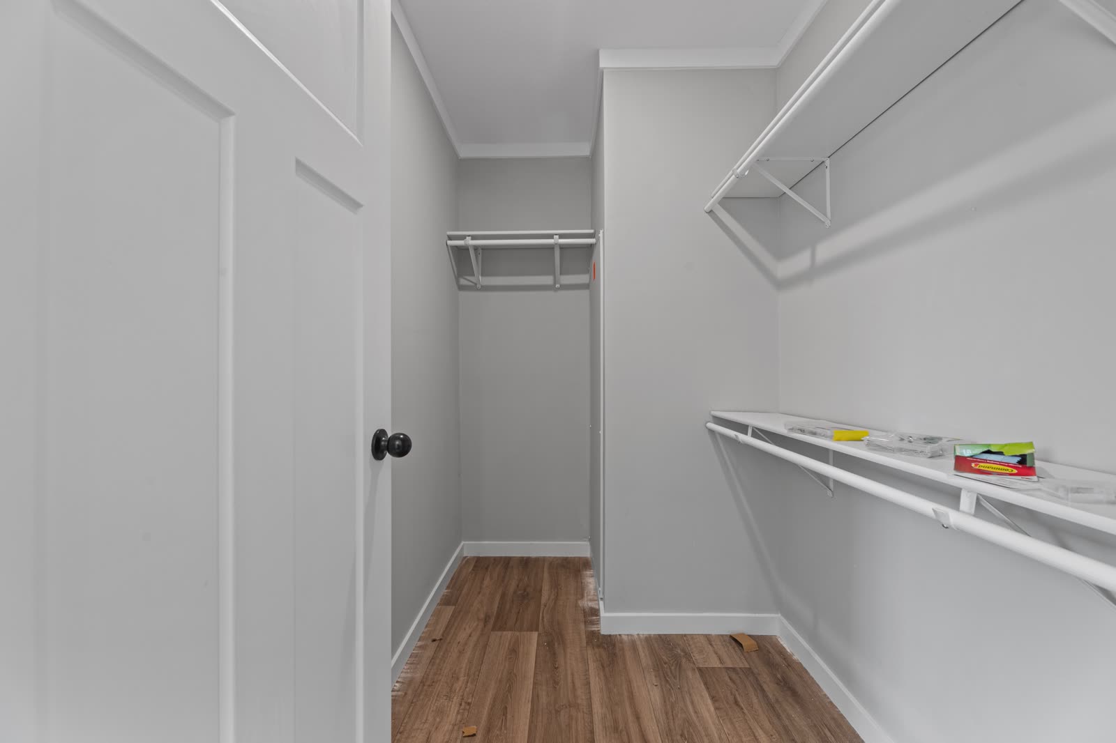 Walk-in closet. Wire shelving, wood floor.