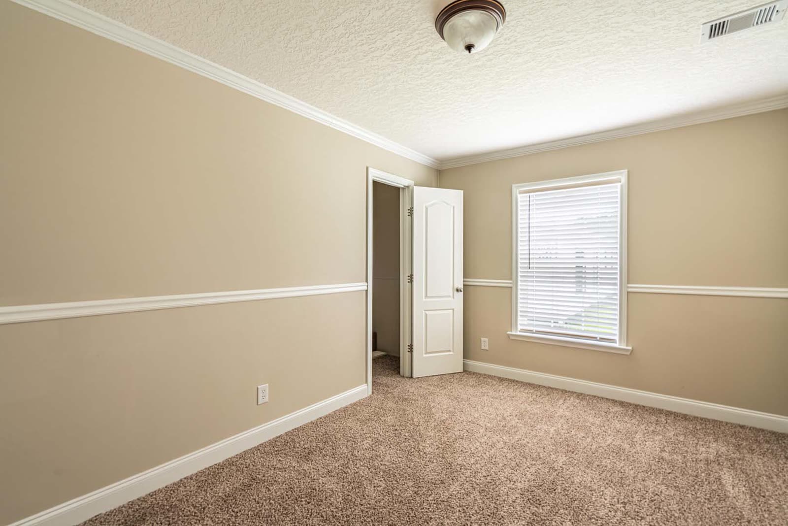 Bedroom. Empty, carpet, window, door to the hall.