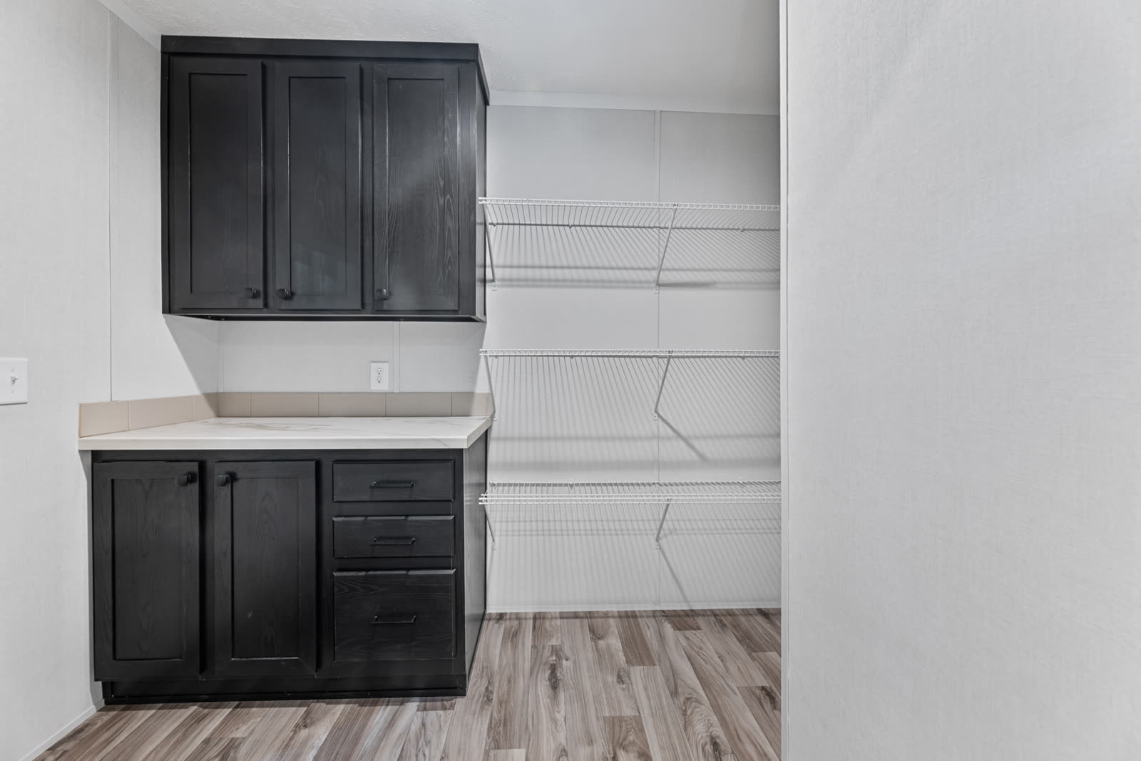 Pantry. Dark cabinet over a counter, wire shelving.