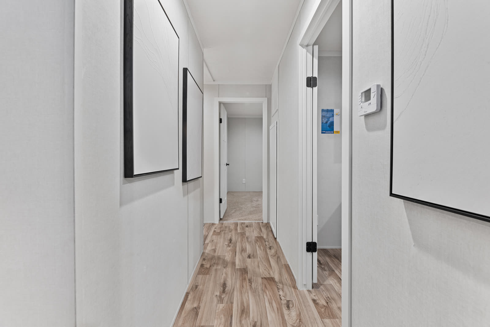 Hall to the bedrooms. Doors to the bedrooms and bath, thermostat.