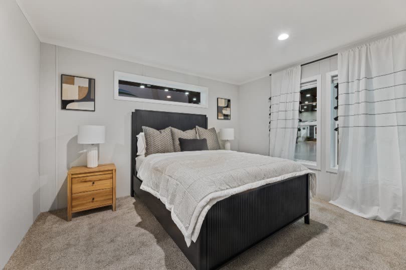 Bedroom 1. Bed and nightstands, curtained window.