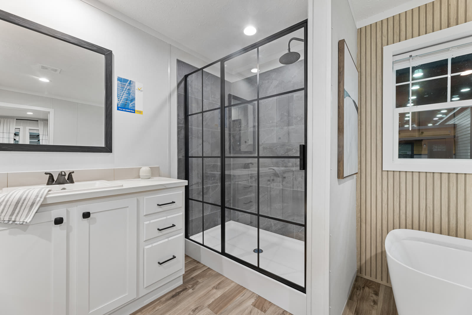 Bath 1. Vanity, black-framed tiled shower, tub.