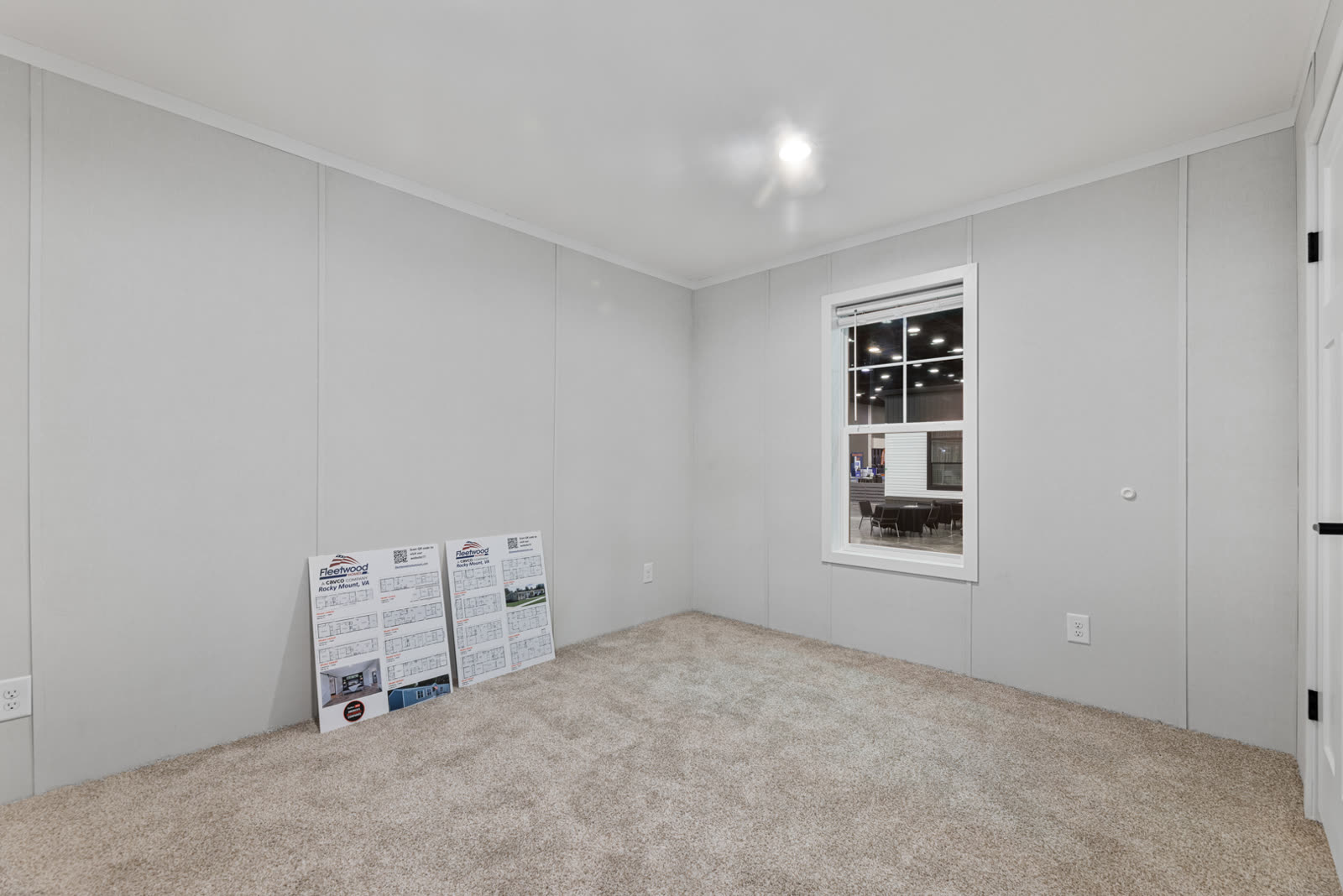 Secondary bedroom. Empty, carpet, window, sign boards on the floor.