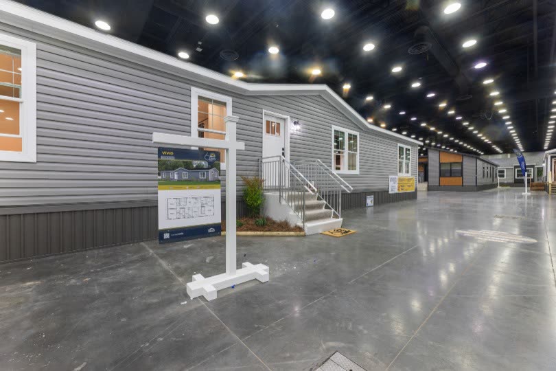 Front entry. Steps to the door, plan sign, show floor.