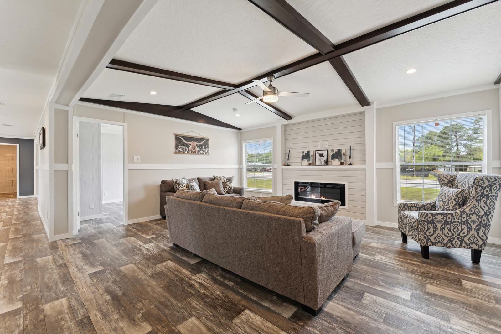 Family room, first furnishing. Sofa facing the fireplace, armchair, window.