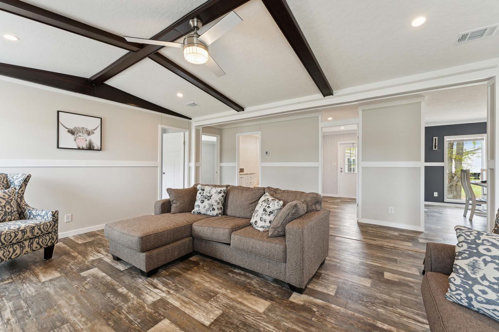 Family room, first furnishing. Sectional sofa, armchair, hall doors beyond.