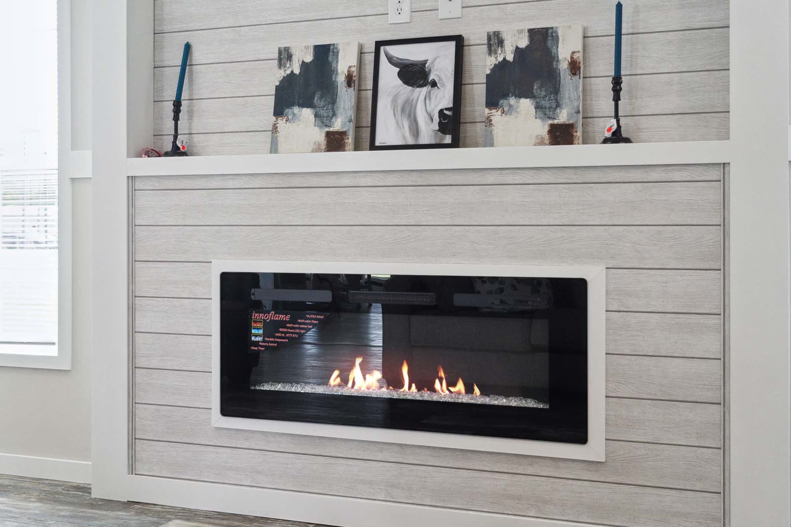 Family room. Electric fireplace in a shiplap surround with mantel.