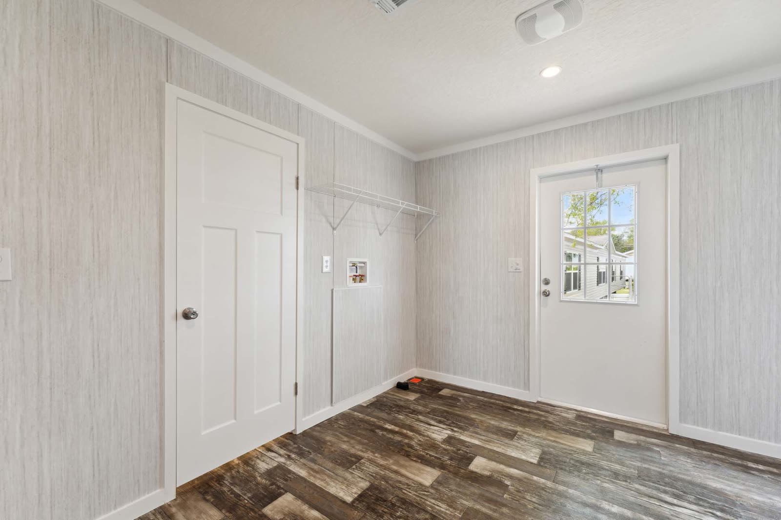 Utility room. Exterior door with window, shelf, washer and dryer hookups.