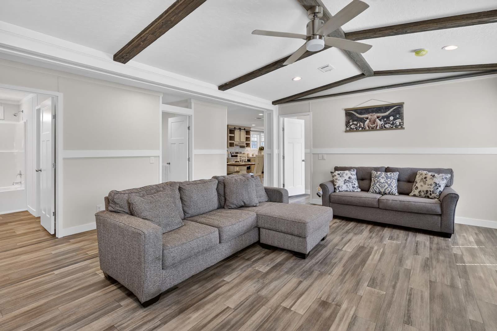 Family room. Sectional and sofa, hall doors beyond.