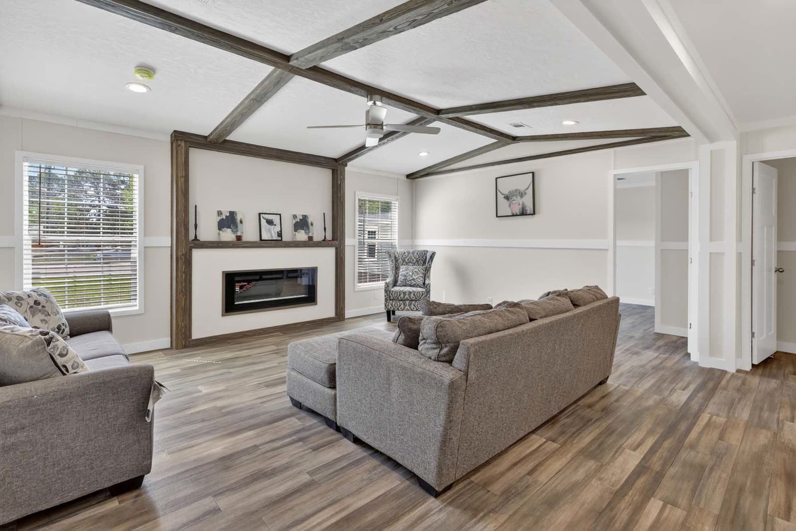 Family room. Fireplace in a wood surround, sofas, windows.