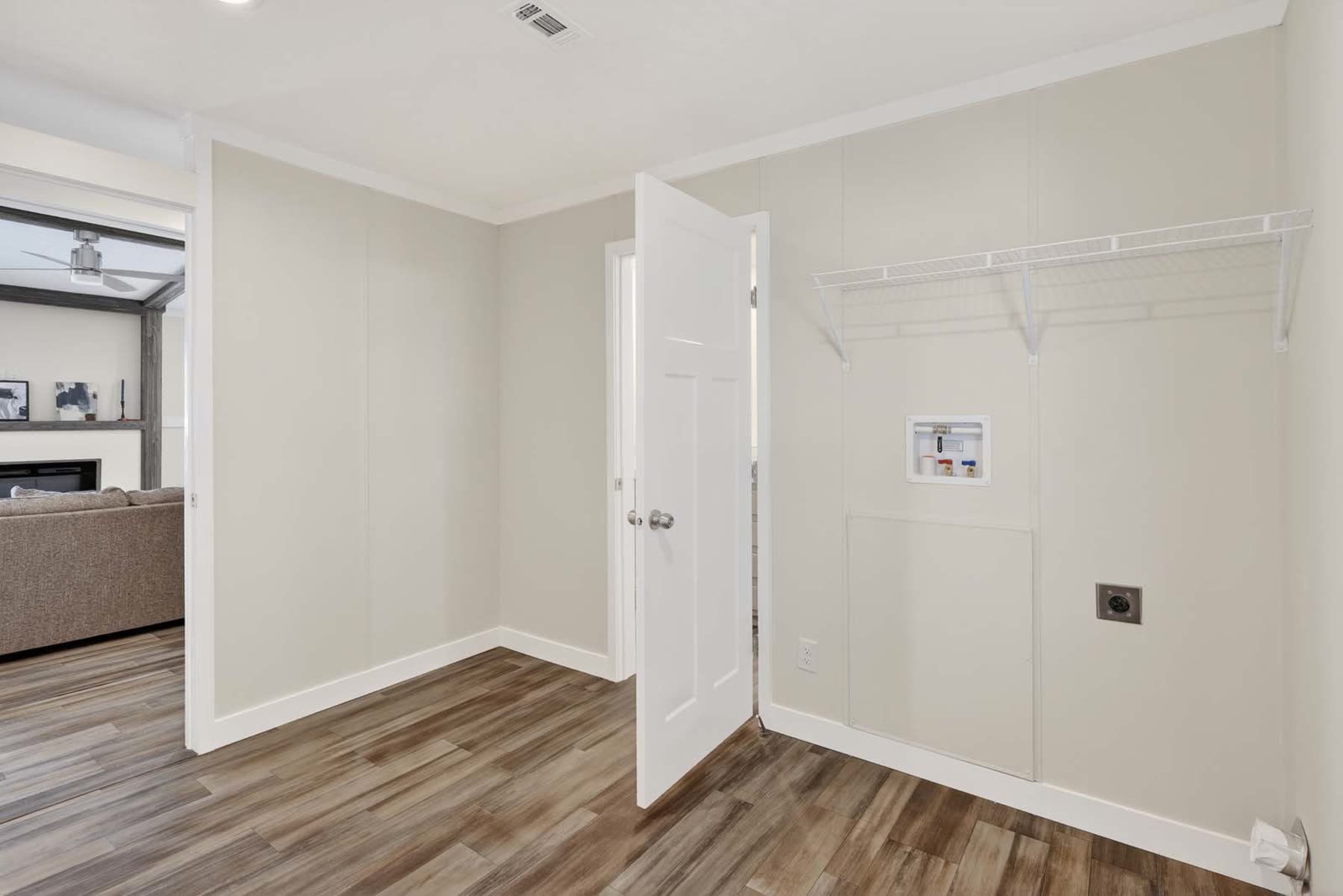 Utility room. Wire shelf, washer and dryer hookups, door to the family room.