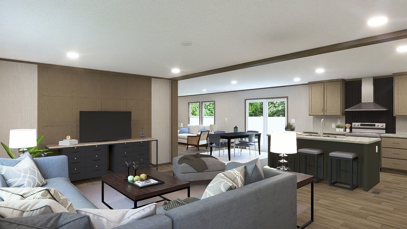 Living room toward the kitchen. Grey sectional, television wall, dining table and island beyond.