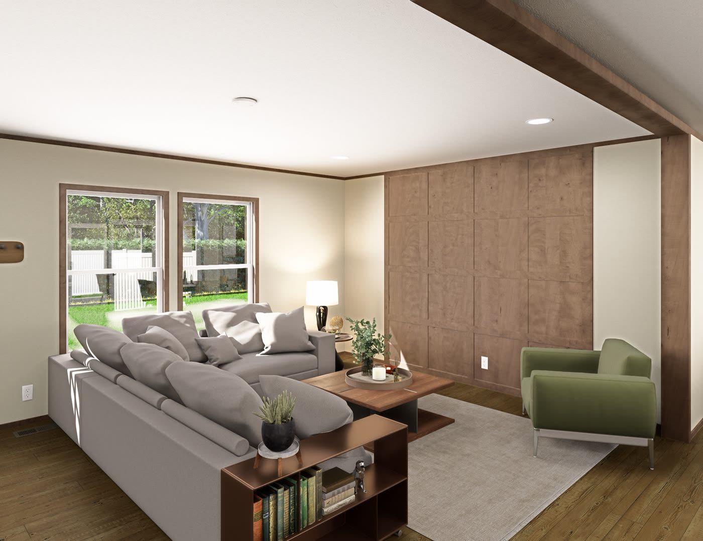 Living room. Grey sectional, wood feature wall, green armchair, windows to the lot.