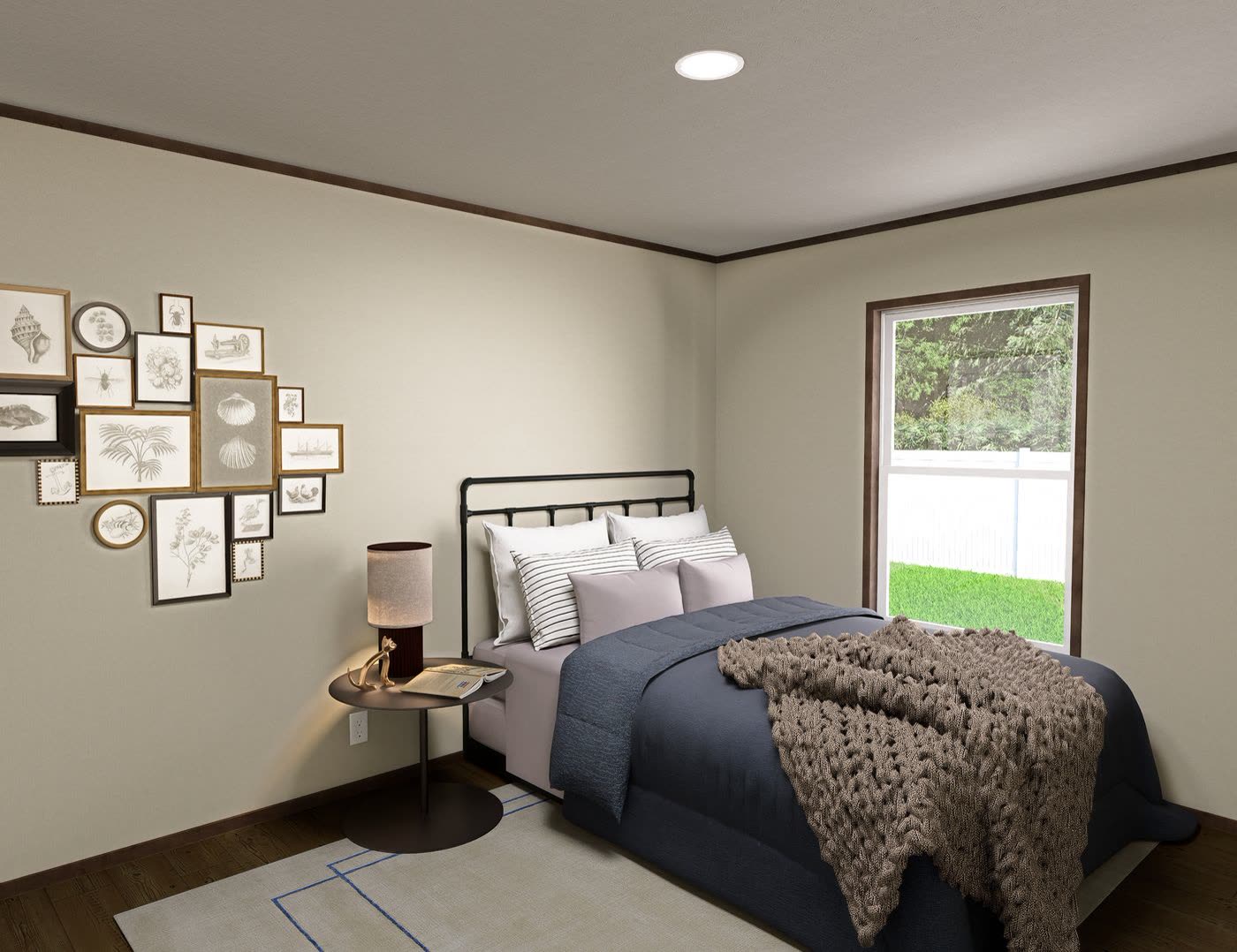 Guest bedroom. Black iron bed with blue cover, gallery wall, window.