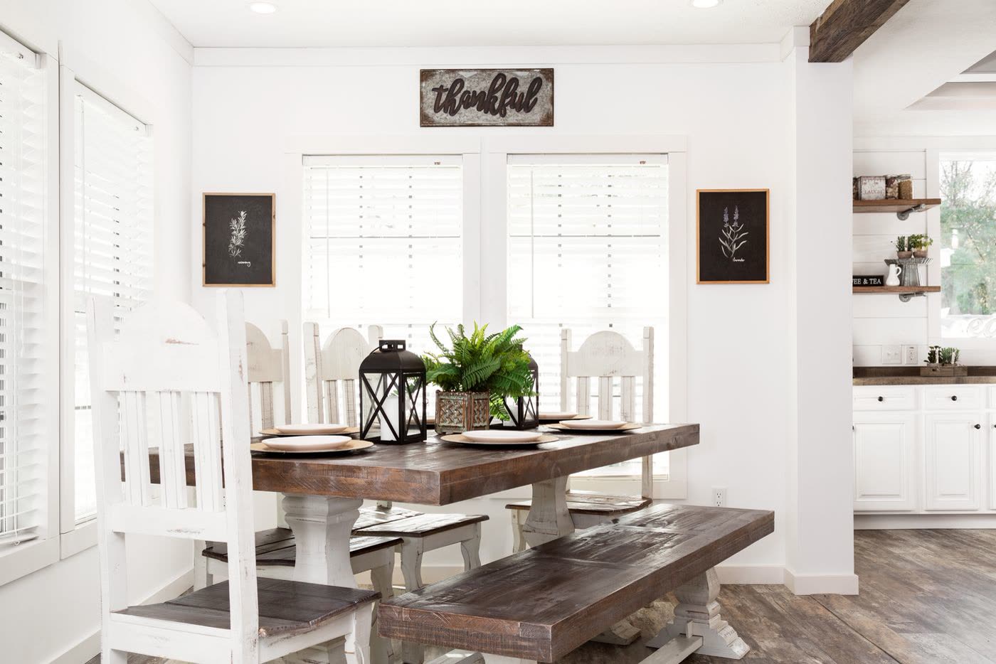 Dining. Farmhouse table with a bench and white chairs under the window.
