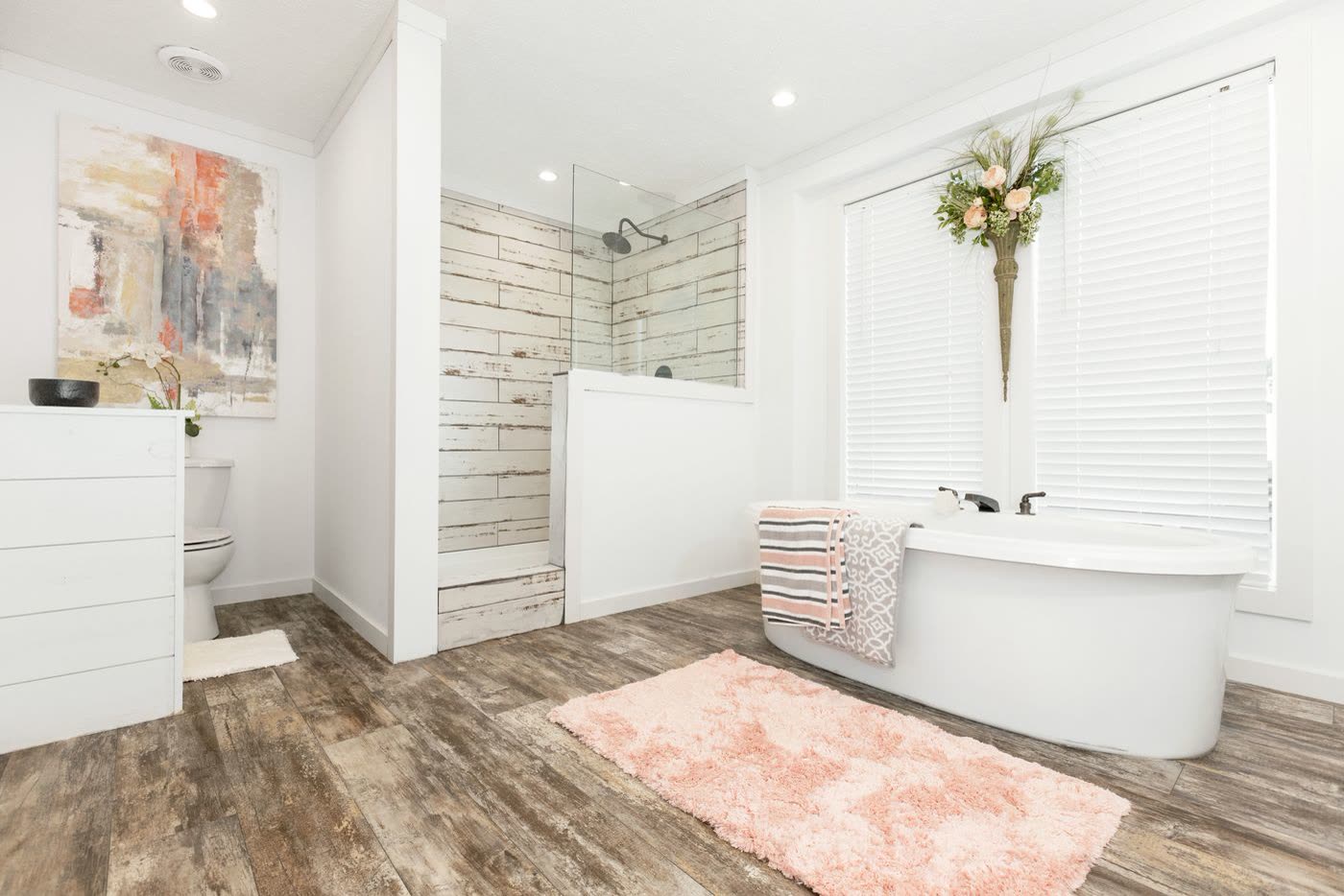 Primary bath. Freestanding tub under the window, tiled walk-in shower, water closet on the left.