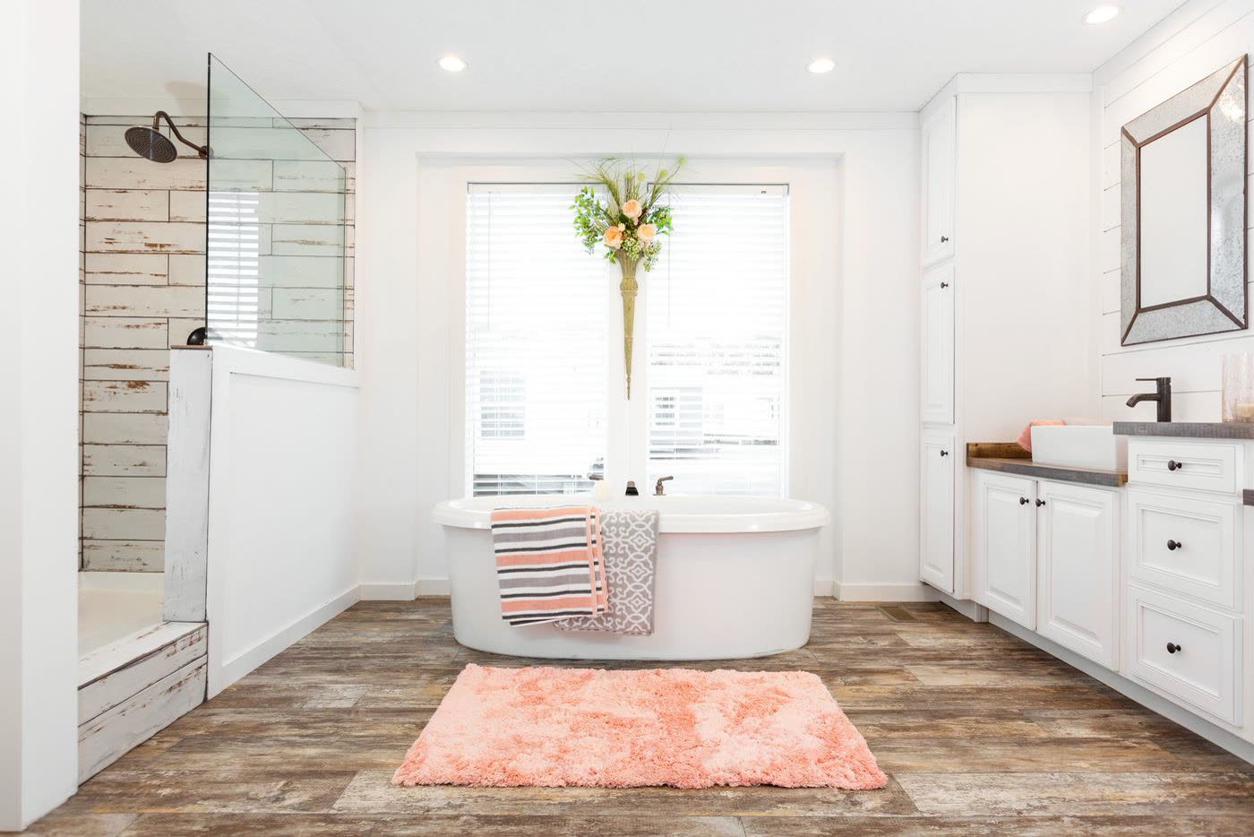 Primary bath. Tub, shower with glass panel, vanity on the right.