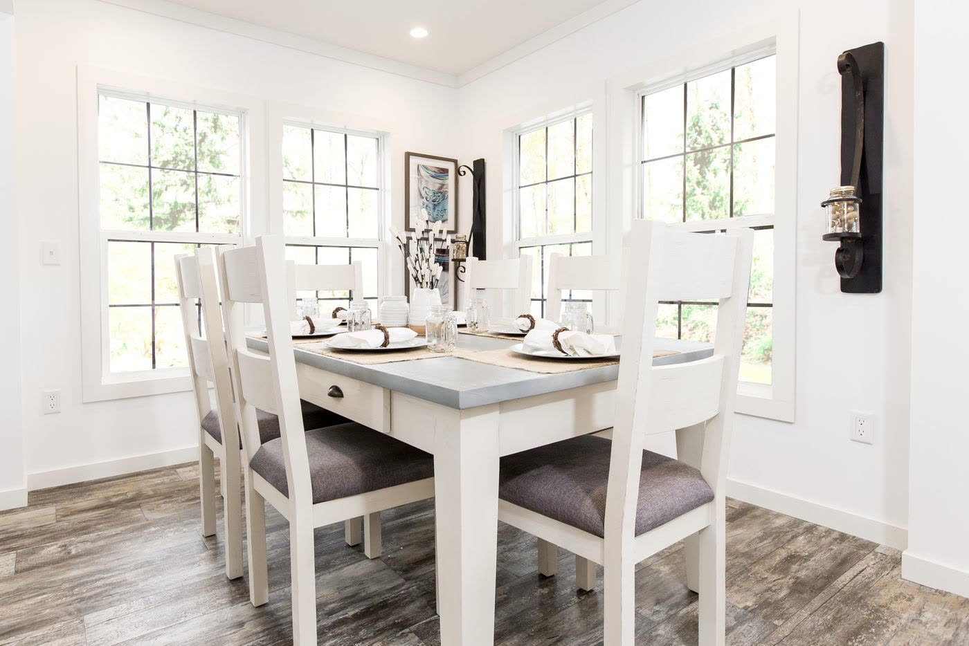 Dining, second furnishing. White table and chairs at the corner windows.