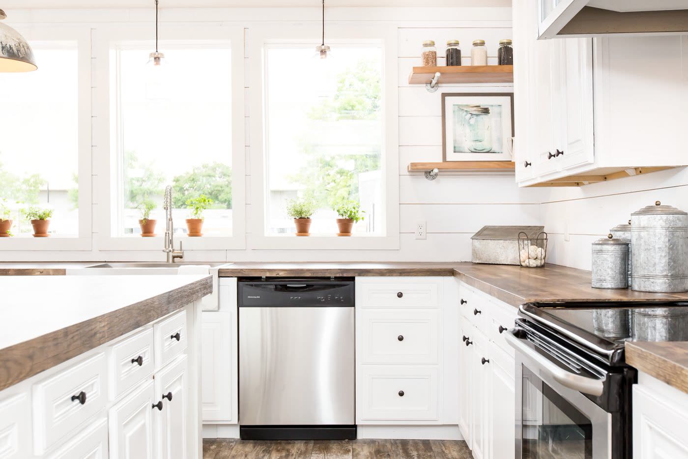 Kitchen, second furnishing. Windows over the farmhouse sink, dishwasher, range.