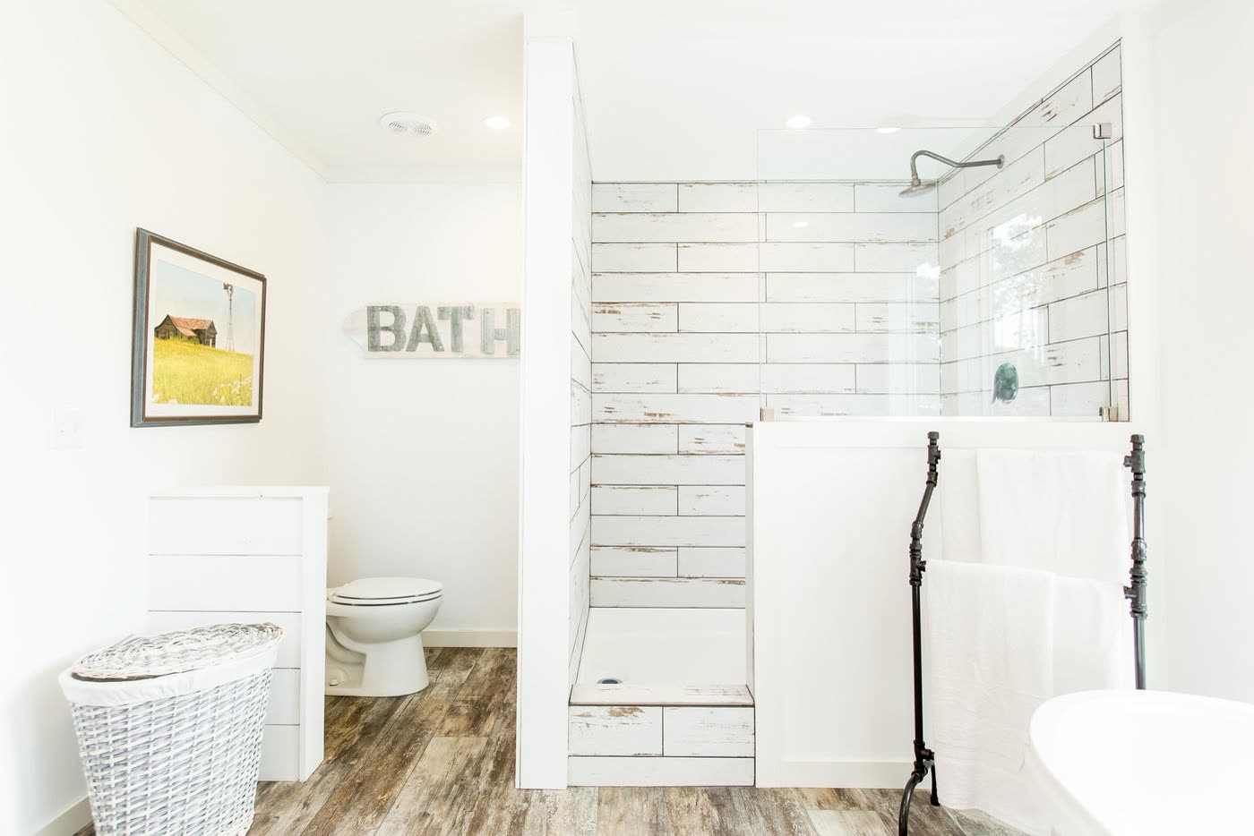 Primary bath, second furnishing. Water closet, tiled shower, edge of the tub on the right.