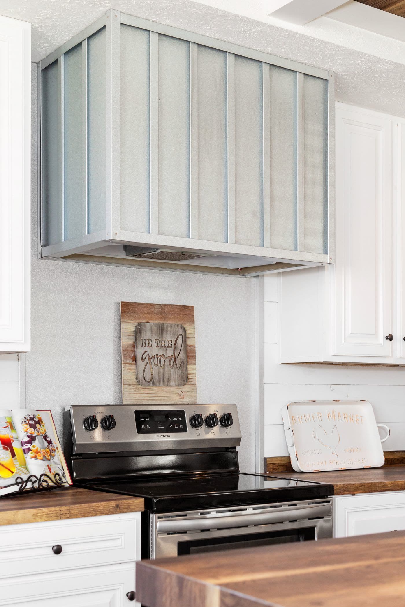 Kitchen. Range hood, stainless range, wood counter.