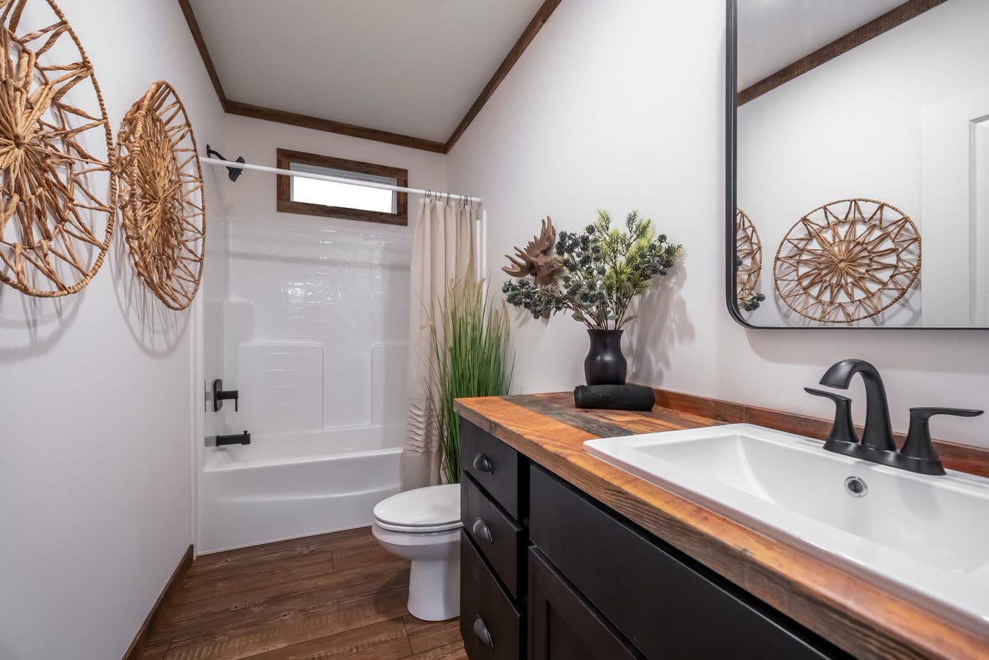2nd bath. Tub with shower, toilet, single vanity, black fixtures.