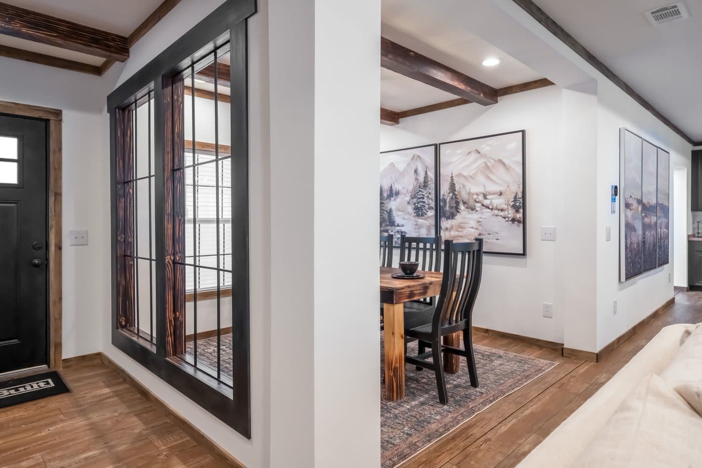 Foyer. Front door at left, glass partition to the dining room.